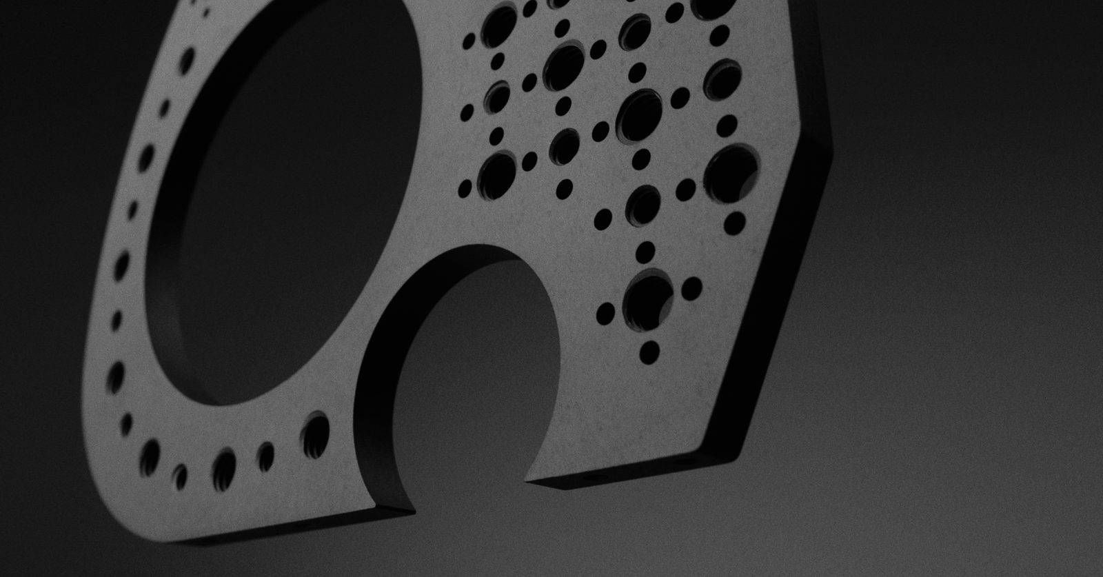 The side plate angled, showing the lens bore and the grid of tapped holes