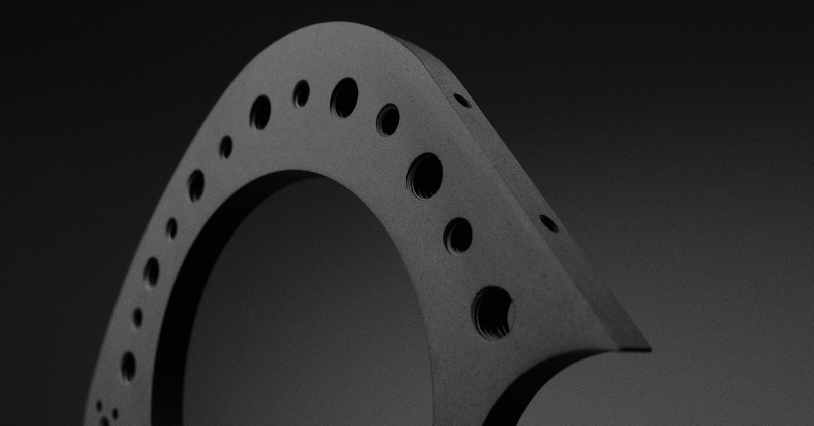 The side plate close in, showing the bore edge and the hole pattern